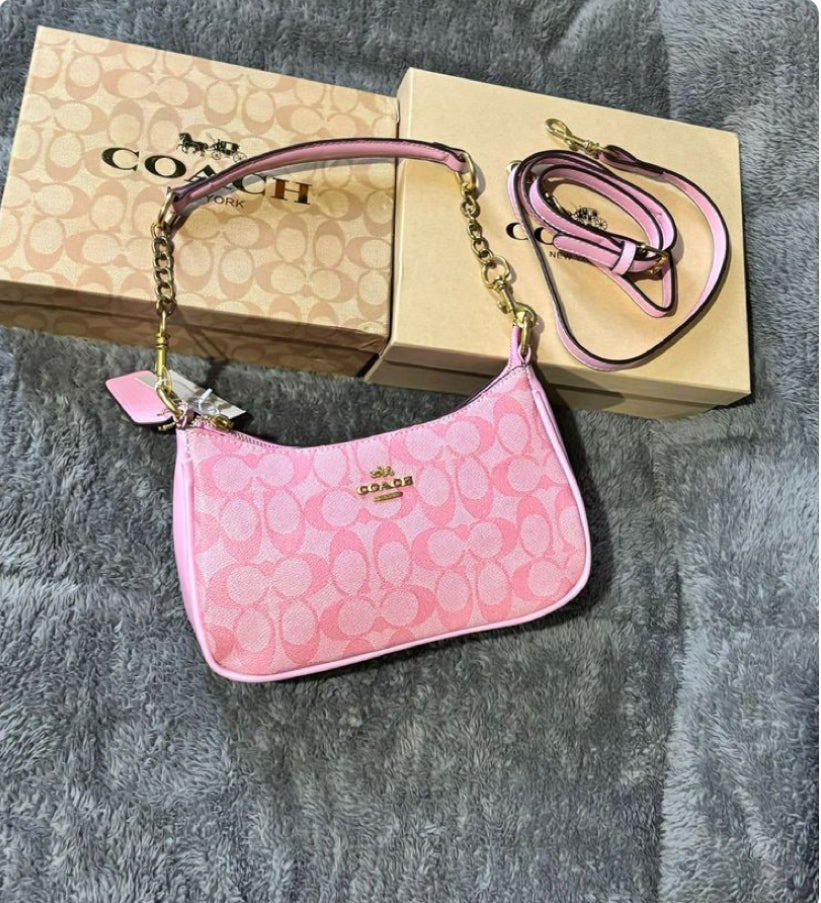 Pink signature coach hand bag , with cute cherry charm