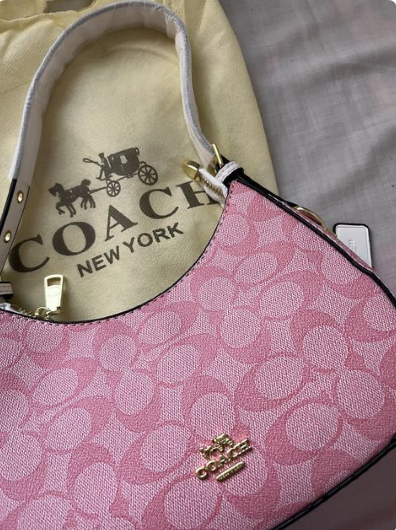Pink signature coach hand bag , with cute cherry charm