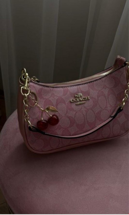 Pink signature coach hand bag , with cute cherry charm