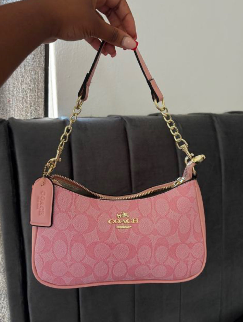 Pink signature coach hand bag , with cute cherry charm