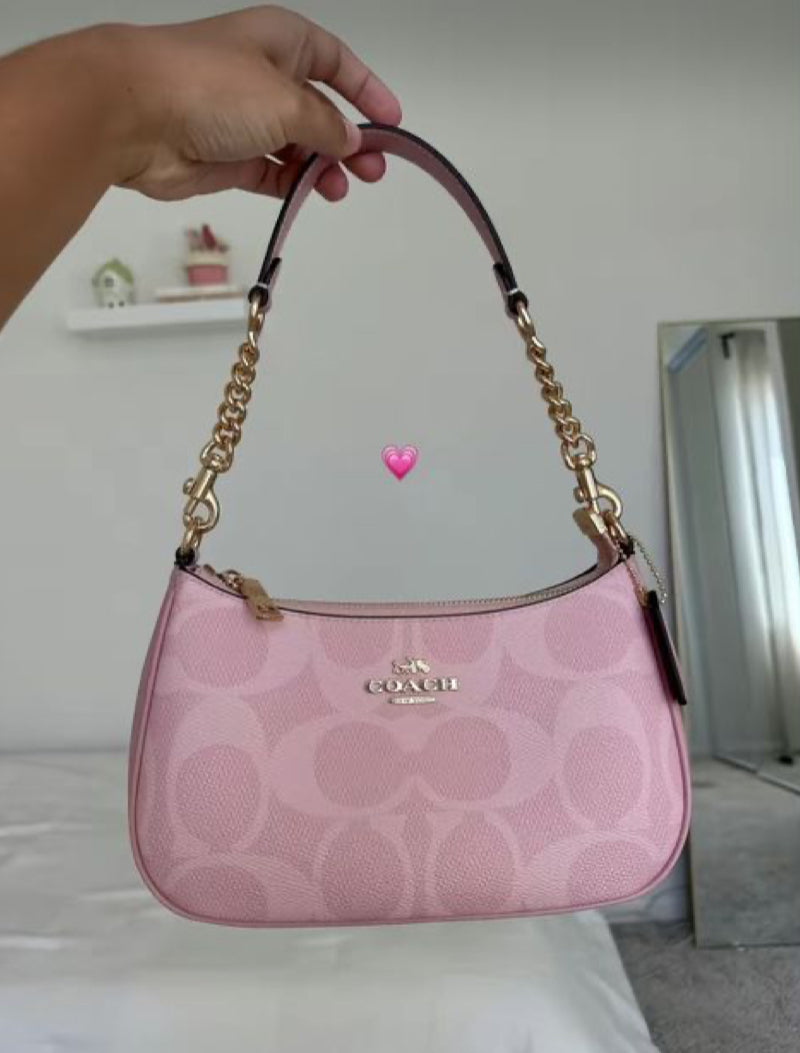 Pink signature coach hand bag , with cute cherry charm
